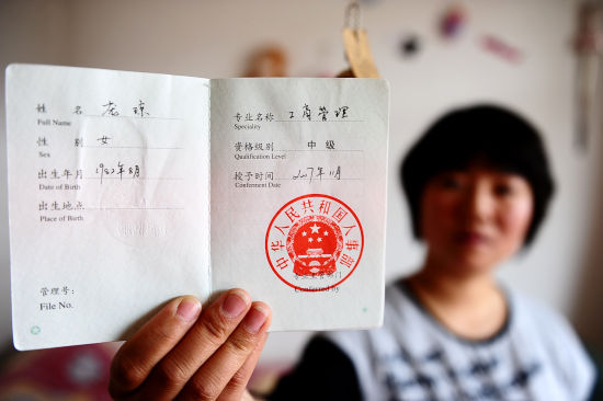 5月17日,中国铝业青海分公司职工庞琼在向记者展示她考取的中级职称资格证书。新华社记者张宏祥摄 5月17日,中国铝业青海分公司职工庞琼在向记者展示她考取的中级职称资格证书。新华社记者张宏祥摄